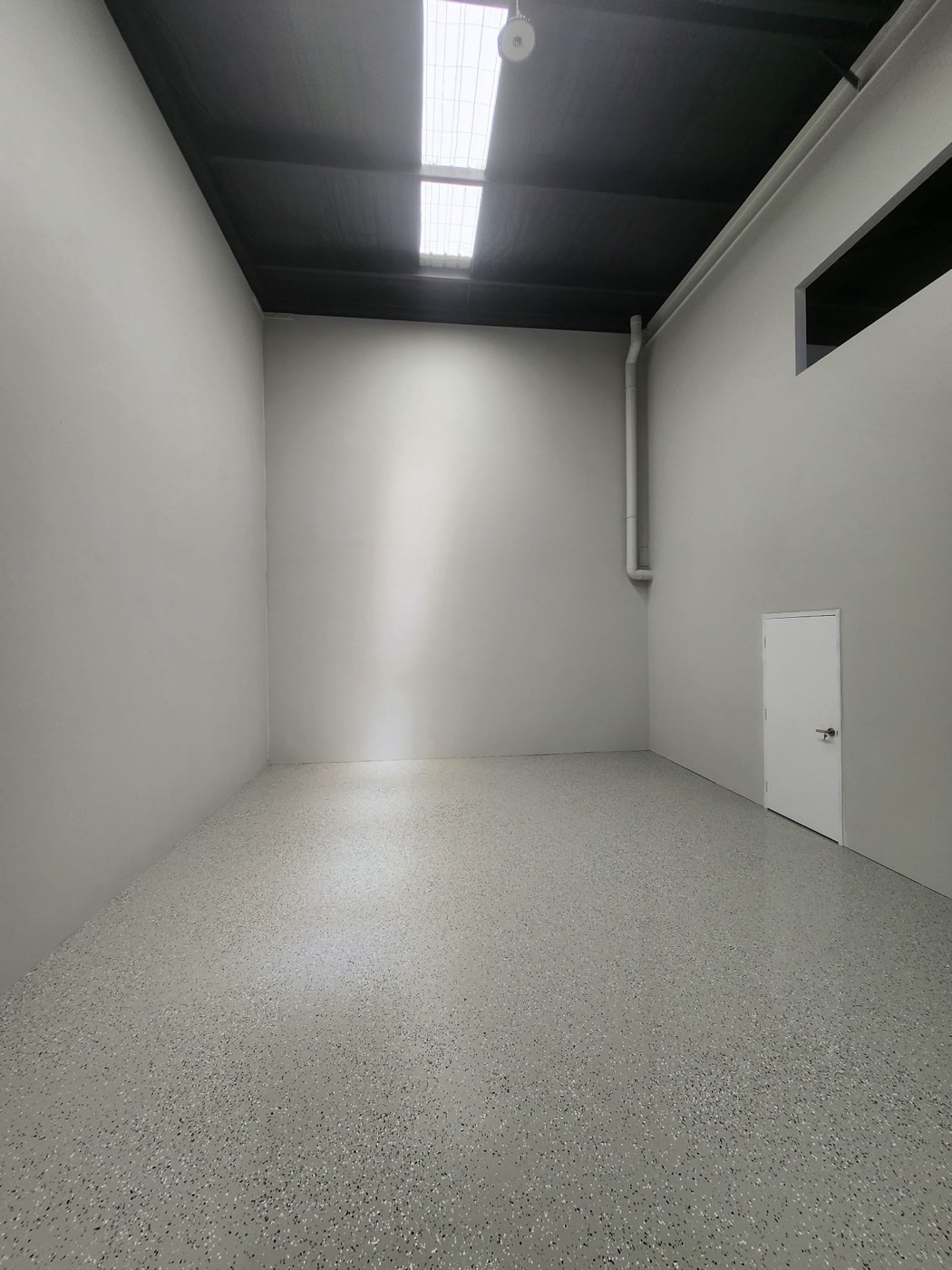 Light grey flake epoxy floor in a commercial unit